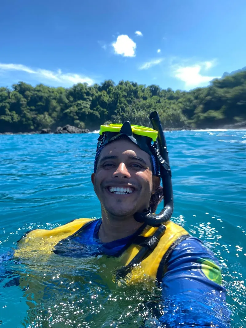 Snorkeler surrounded by eagle rays and tropical fish at Caño Island on a full-day snorkeling uvita Costa Rica marine immersion tour